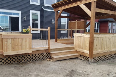 Inspiration for a medium sized traditional back terrace in Calgary with an outdoor kitchen and a pergola.