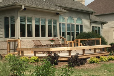 Example of a small classic backyard deck design in Detroit with no cover