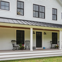 https://www.houzz.com/hznb/photos/coastal-modern-farmhouse-with-black-metal-roof-and-wraparound-porch-farmhouse-deck-bridgeport-phvw-vp~147649002