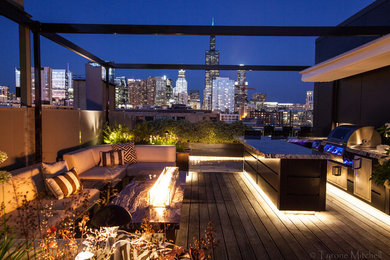 Example of a mid-sized trendy rooftop deck design in Chicago with a fire pit and a pergola