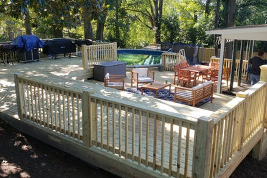 Large arts and crafts backyard outdoor kitchen deck photo in Atlanta with no cover