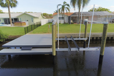 Inspiration for a small coastal backyard dock remodel in Tampa with no cover