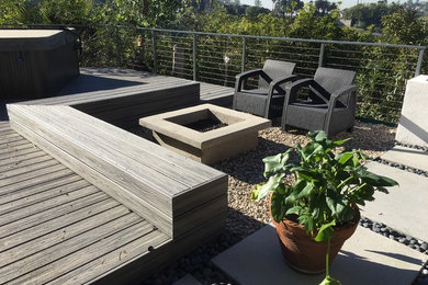 Inspiration for a large modern backyard deck remodel in Los Angeles with a fire pit and no cover
