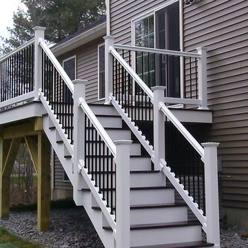 Composite deck with black metal balusters on white railings is stunning!