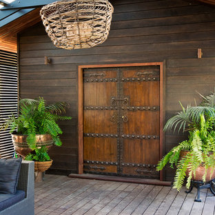 Inspiration for a mid-sized beach style deck in Sydney with a pergola and a container garden.