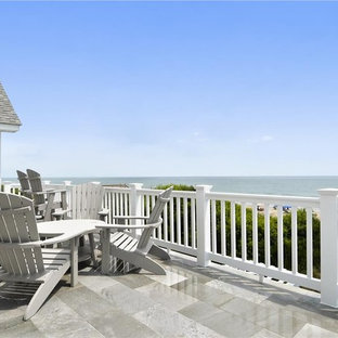 Example of a mid-sized beach style backyard deck design in Other with no cover