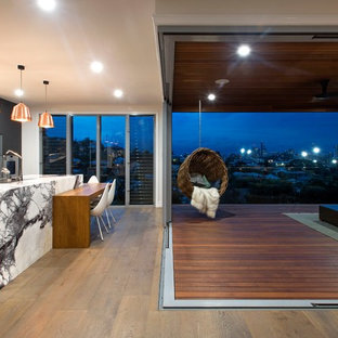 Photo of a contemporary deck in Brisbane with a roof extension.