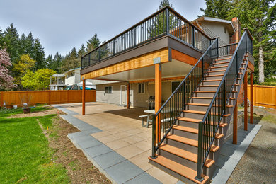 Example of a mid-sized minimalist backyard deck design in Seattle