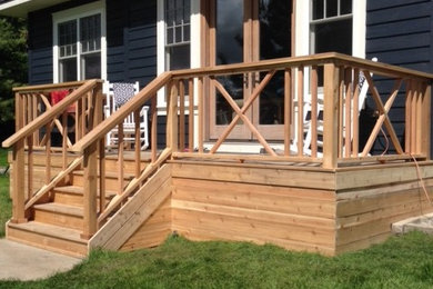 Example of a beach style backyard deck design in Ottawa with no cover
