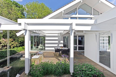 Inspiration for a mid-sized modern deck remodel in Stuttgart with a pergola