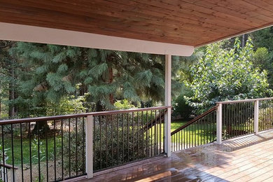 Inspiration for a large timeless backyard deck remodel in Sacramento with a roof extension