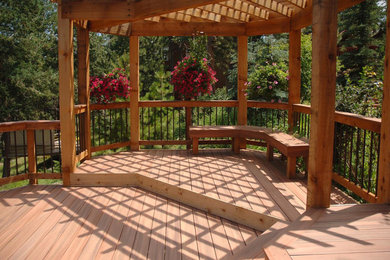 Inspiration for a large rustic backyard deck remodel in Los Angeles with a pergola