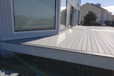 Deck - large modern backyard deck idea in Seattle with no cover