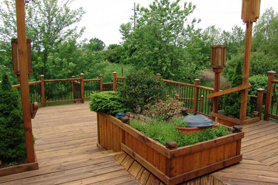 Deck - large traditional backyard deck idea in Grand Rapids