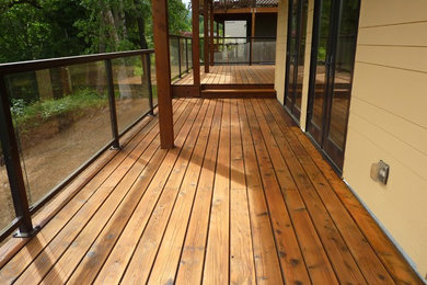 Example of an arts and crafts backyard deck design in Portland with an awning