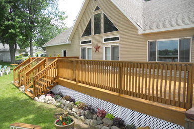Deck - large farmhouse backyard deck idea in Grand Rapids with no cover