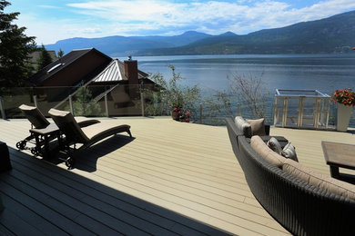 Deck - large modern backyard deck idea in Vancouver with no cover