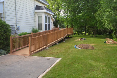 Example of a mid-sized classic backyard deck design in Toronto with no cover