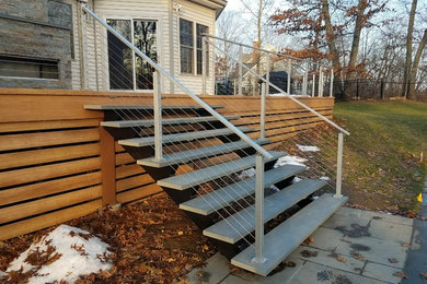 Deck with stainless steel cable railing, steel and stone floating stairs & porch