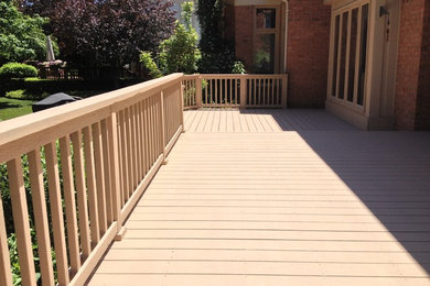Example of a large classic backyard deck design in Detroit with no cover