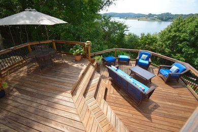 Deck - large tropical backyard deck idea in Other with no cover