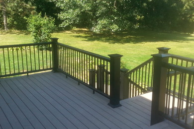 Example of a mid-sized classic backyard deck design in Detroit with no cover