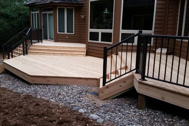 Example of a mid-sized classic backyard deck design in Minneapolis