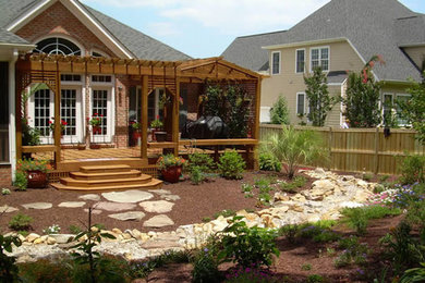 Inspiration for a mid-sized backyard deck remodel in Other with a pergola