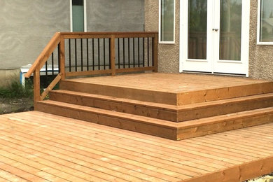 Example of a large backyard deck design in Other with no cover