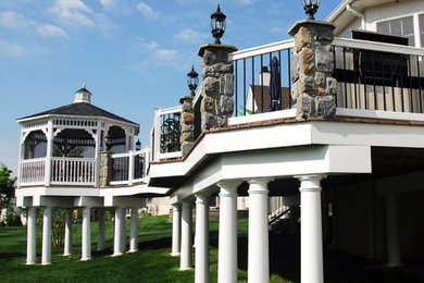 Inspiration for a large timeless backyard deck remodel in Philadelphia with a pergola