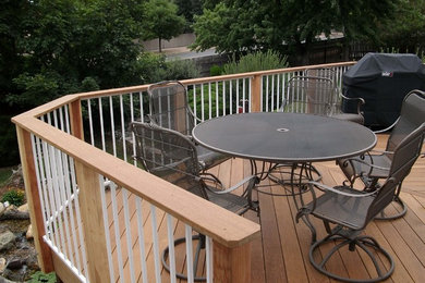 Deck - mid-sized traditional backyard deck idea in Denver with a roof extension