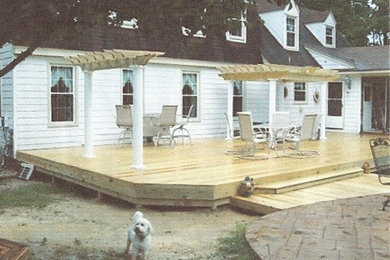 Deck - traditional backyard deck idea in Other with a pergola