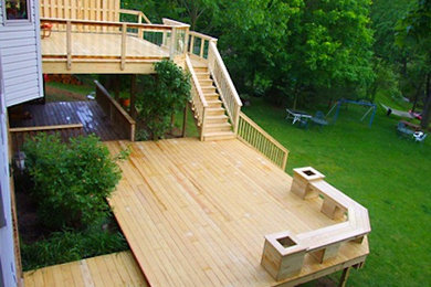 Example of a large backyard deck design in Cleveland with no cover