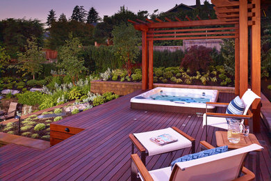 Example of a trendy backyard deck design in Vancouver with a pergola