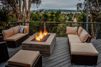 Inspiration for a mid-sized modern backyard deck remodel in San Diego with a fire pit and no cover
