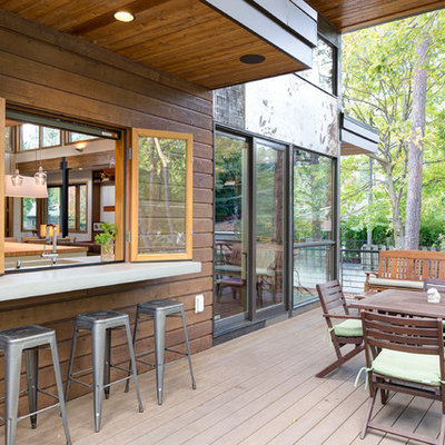Example of a mid-sized minimalist backyard outdoor kitchen deck design in Seattle with no cover