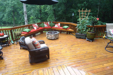 Deck - mid-sized craftsman backyard deck idea in Other with a roof extension