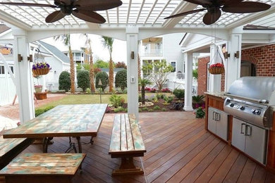 Inspiration for a coastal backyard outdoor kitchen deck remodel in Other with a pergola