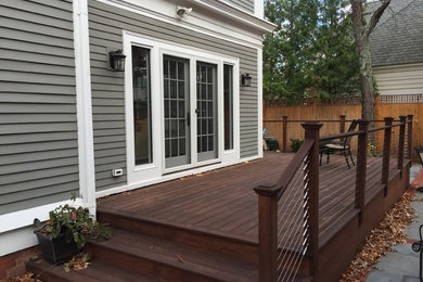 Mid-sized trendy side yard deck photo in Providence with no cover