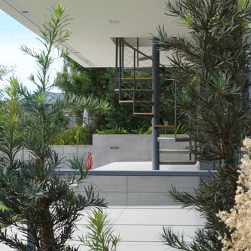 Exterior concrete deck patio with spiral staircase.