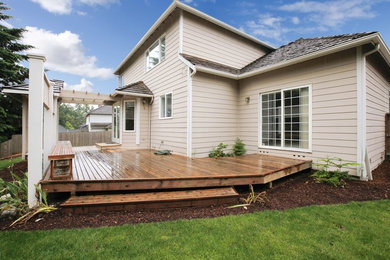 Foto de terraza de estilo americano de tamaño medio en patio trasero con pérgola