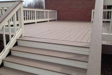 Example of a large classic backyard deck design in Louisville with no cover