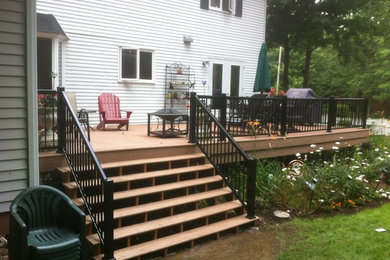Example of a mid-sized classic backyard deck design in Other with a fire pit and no cover