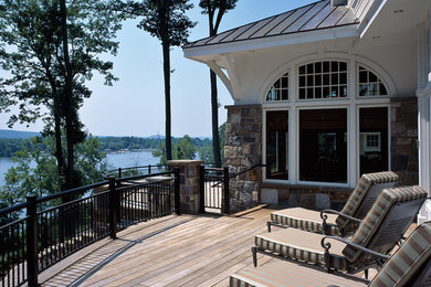 Inspiration for a huge timeless backyard deck remodel in Boston with a roof extension