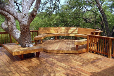 Example of a backyard deck design in Dallas with no cover