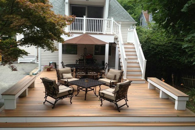 Example of a mid-sized classic backyard deck design in Boston with no cover