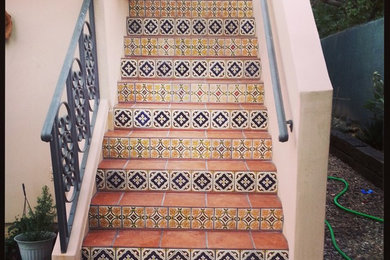Example of a large island style staircase design in Orange County