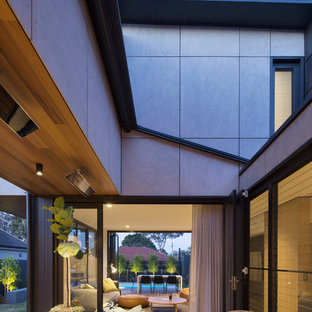 This is an example of a mid-sized contemporary side yard deck in Sydney with an awning.