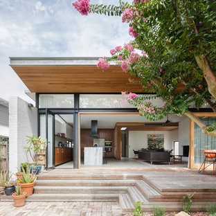 Design ideas for a mid-sized contemporary backyard deck in Sydney with a roof extension.