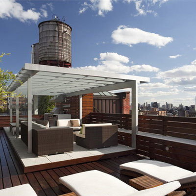 Example of a large minimalist rooftop outdoor kitchen deck design in New York with a pergola